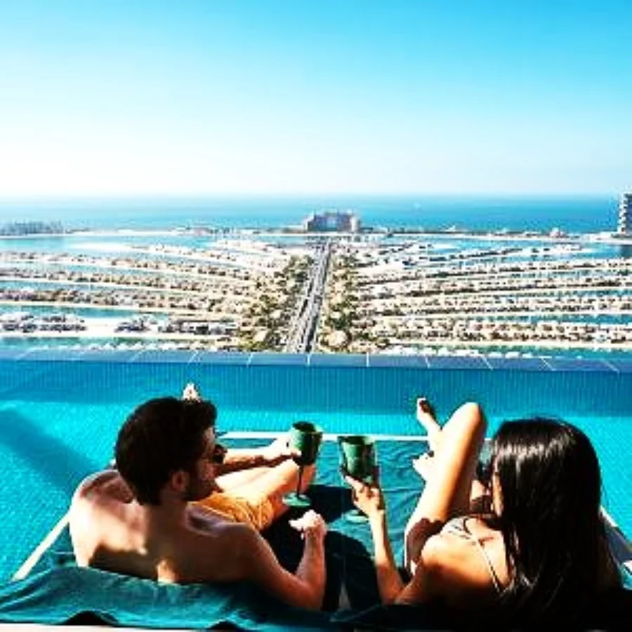 a man and a woman enjoying lying on world's highest infinity pool