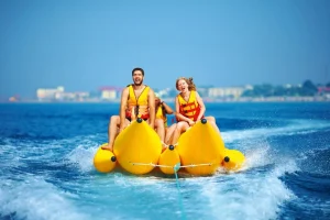 a man and a woman enjoying colorful boatriding at atlantis
