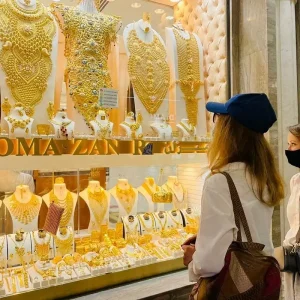 a tourist keenly watching gold souk