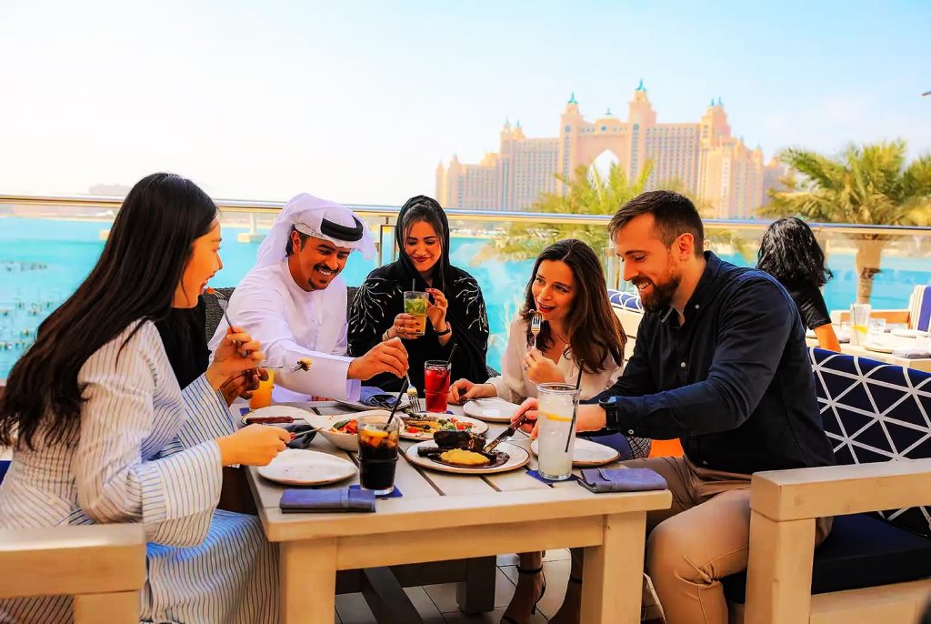 tourist enjoying food at beautiful ocean view open air restaurant